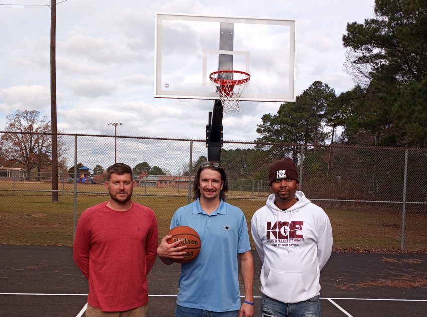The old tennis courts at Westside Community Center have been turned into outdoor public basketball courts. Parks Director Cody Bryan, left, with businessman Philip Prince and Jacob Boler who runs the charity Kids Over Everything, have helped with the project. The courts are expected to be open early next year.